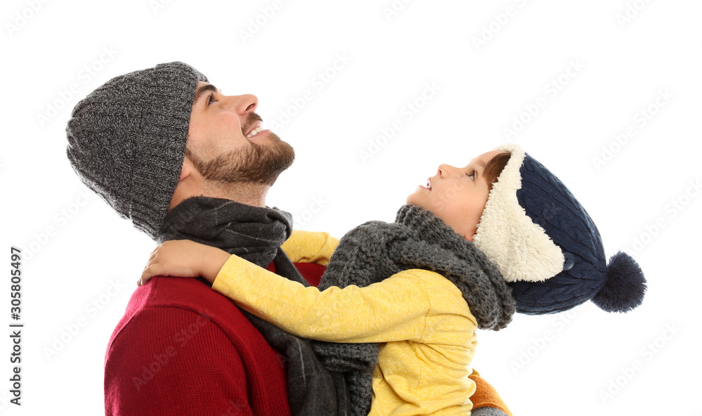 Happy father and son in warm clothes on white background. Winter vacation Happy father and son in warm clothes on white background. Winter vacation