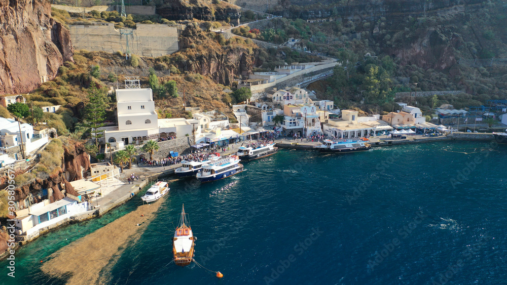 Aerial drone photo of iconic old port of Fira in volcanic island of Santorini, Cyclades, Greece