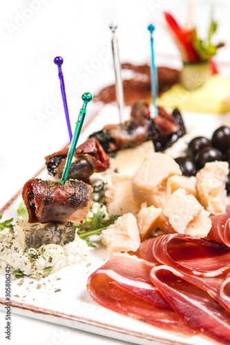 A plate full of fresh dry meat, beautiful olives and the best cheese photo