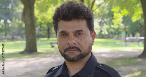 Static shot of a man in a park and staring into the camera - shot on RED photo