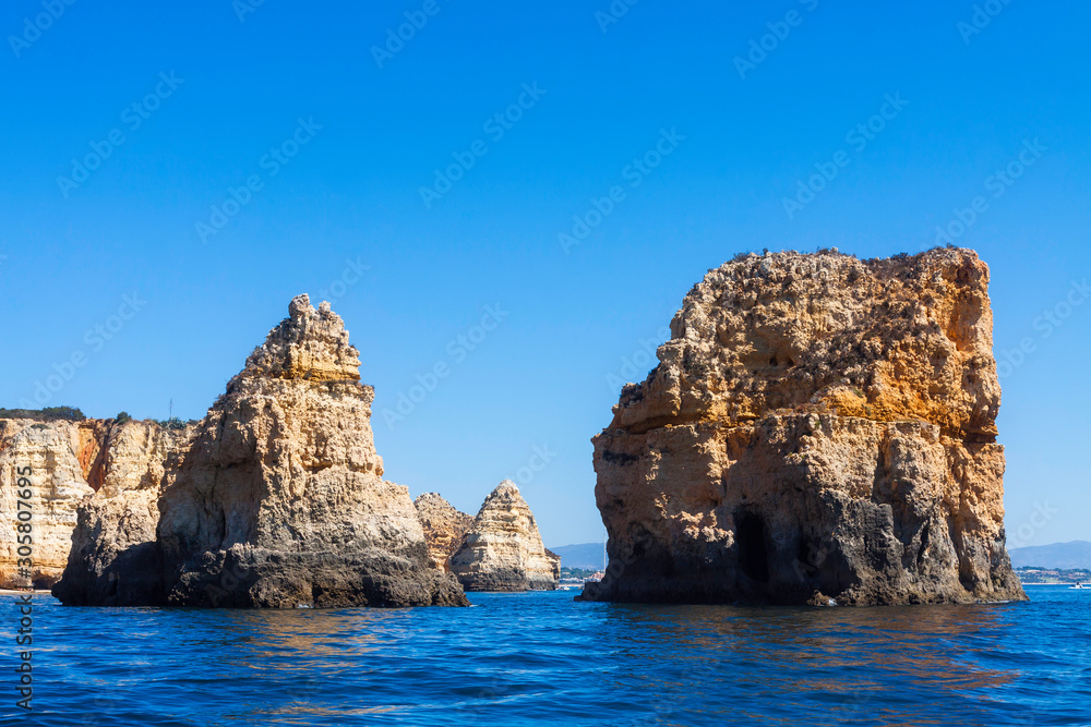 LANDSCAPE ON THE PORTUGAL COAST WITH ROCKS CLIFFS AND BLUE SKY HORIZON