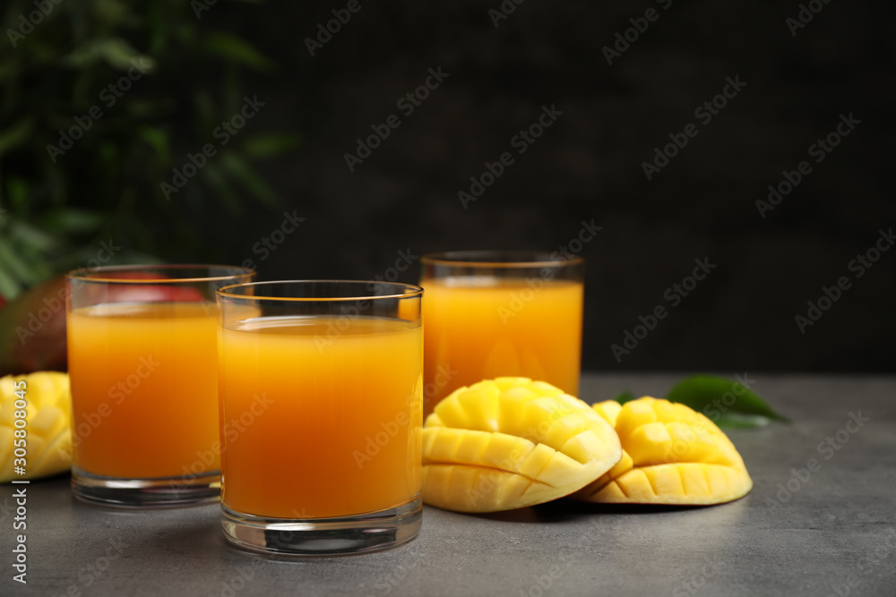 Fresh delicious mango drink on grey table Fresh delicious mango drink on grey table