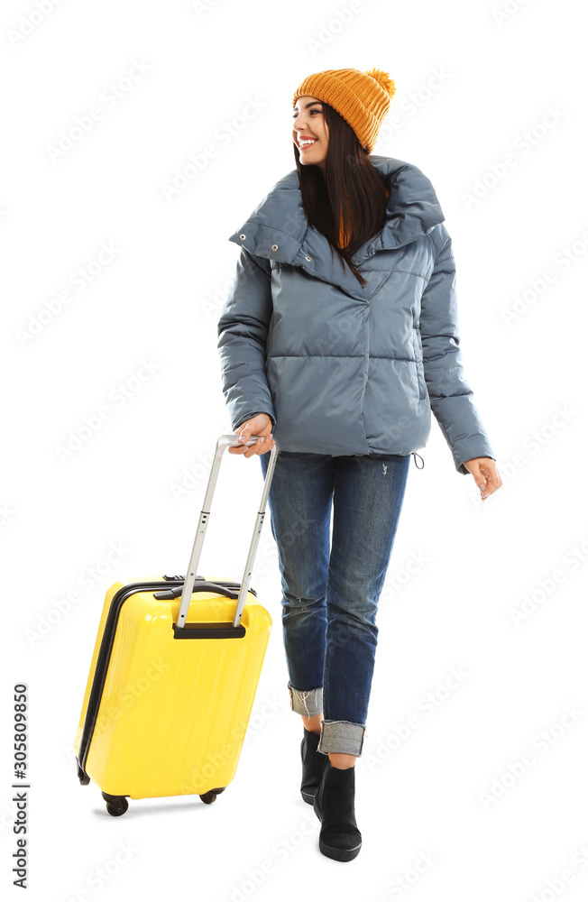 Young woman in warm clothes with suitcase on white background. Winter vacation Young woman in warm clothes with suitcase on white background. Winter vacation