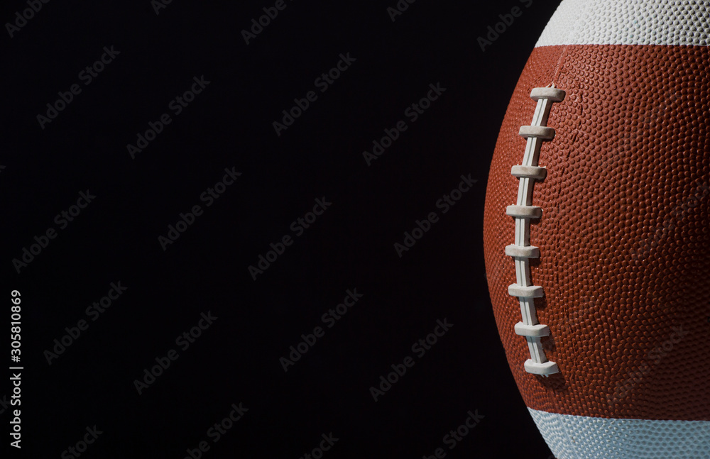 American football ball close up on black background. American football ball close up on black background.