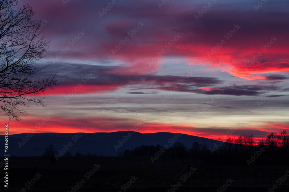 Fototapeta premium Red sunset over mountains