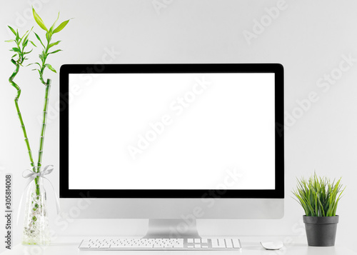 Computer all in one in office table with isolated white screen