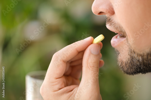 Man taking medicine at home...