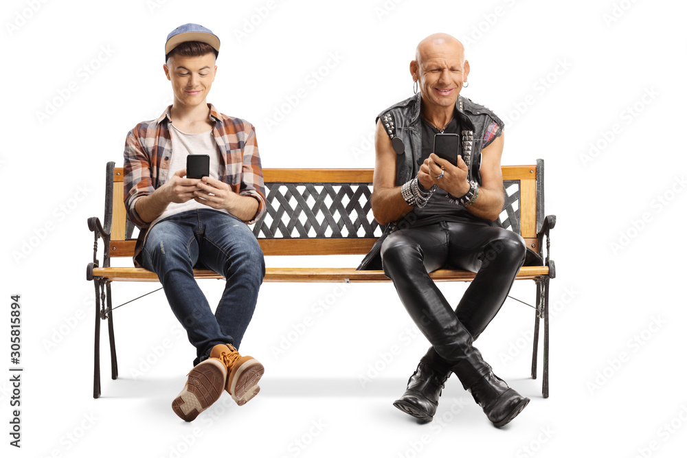 Happy punker and a young guy on a bench using smartphones