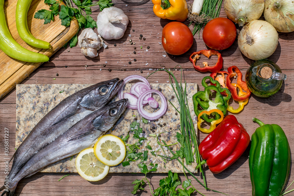 fish and vegetables on the table ready to cook a healthy lunch fish and vegetables on the table ready to cook a healthy lunch