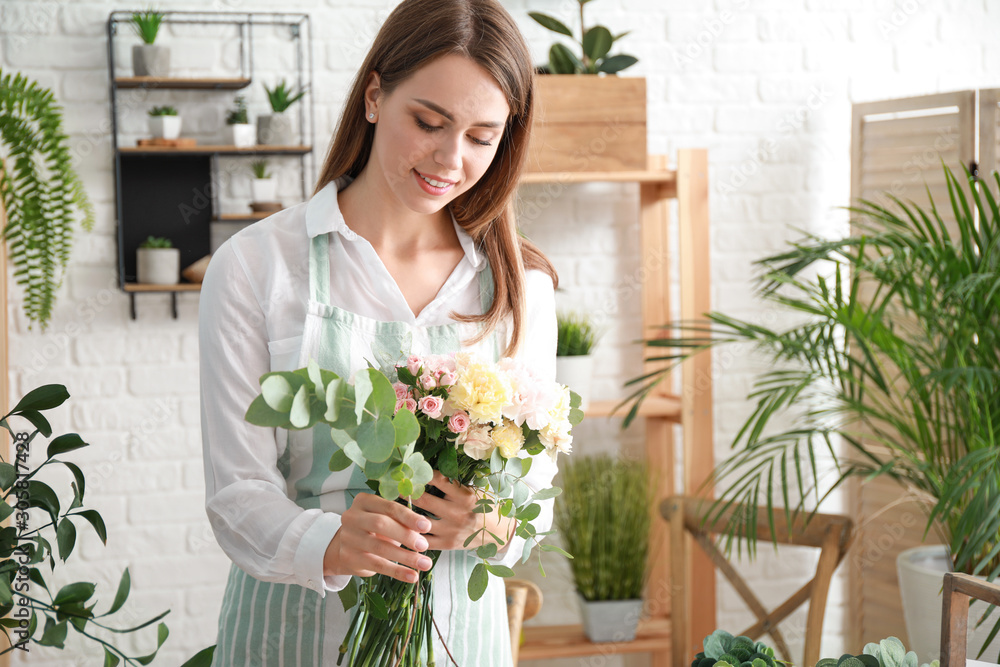 Female florist making beautiful bouquet in shop Female florist making beautiful bouquet in shop