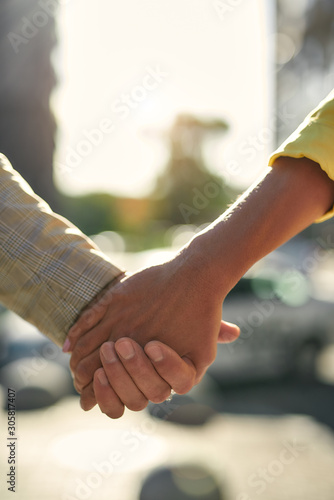 Always together. Cropped photo of couple holding hands while standing outdoors