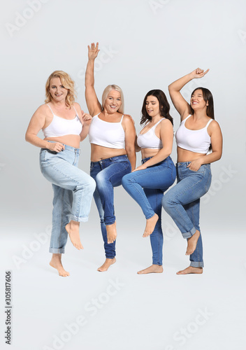 Group of body positive women on grey background