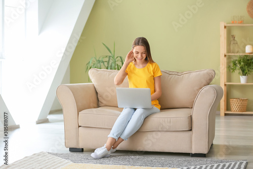 Happy woman with laptop sit...