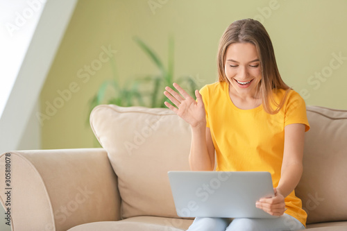 Happy woman with laptop sit...