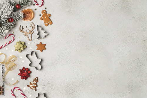 Christmas composition flat lay, fir tree, gingerbread, cookie cutter, candy cane, dried orange, ornaments © Anastasia Turshina