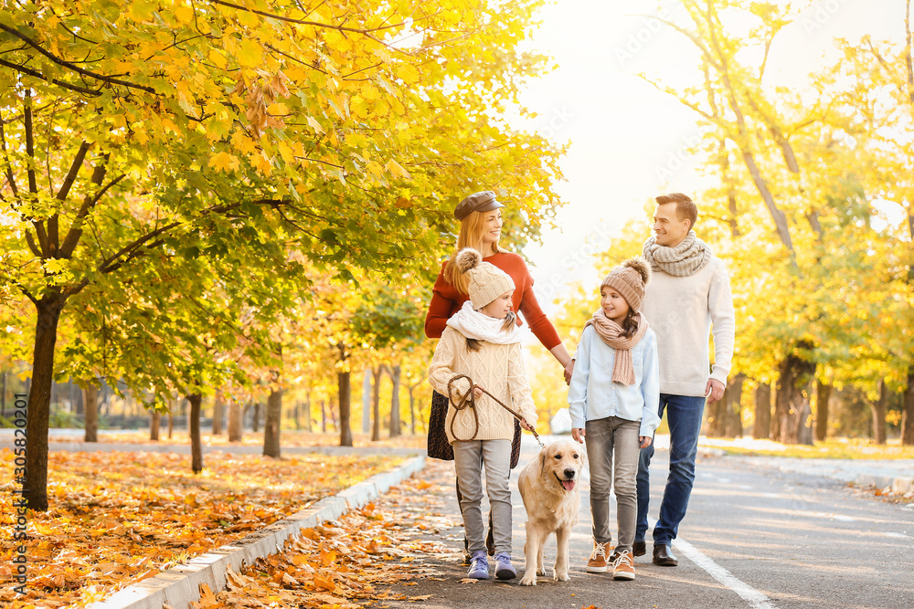 Happy family with dog walking in autumn park Happy family with dog walking in autumn park