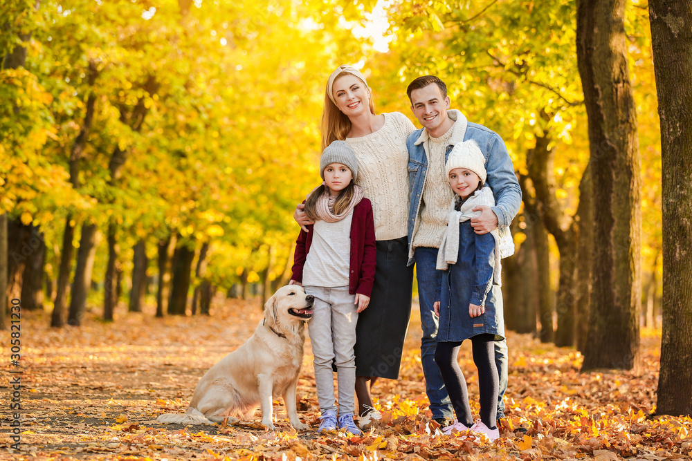 Fototapeta premium Happy family with dog in autumn park