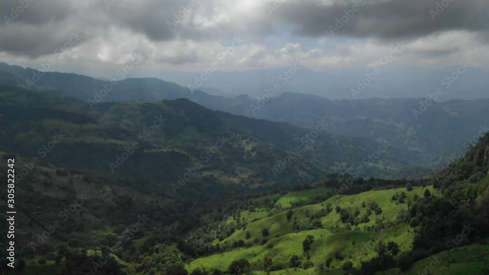 Sunlight on green pastures, trees, forrest and mountains. Scenic panoramic aerial drone view of beautiful nature. Camera moving forward. Sunlight on green pastures, trees, forrest and mountains. Scenic panoramic aerial drone view of beautiful nature. Camera moving forward.