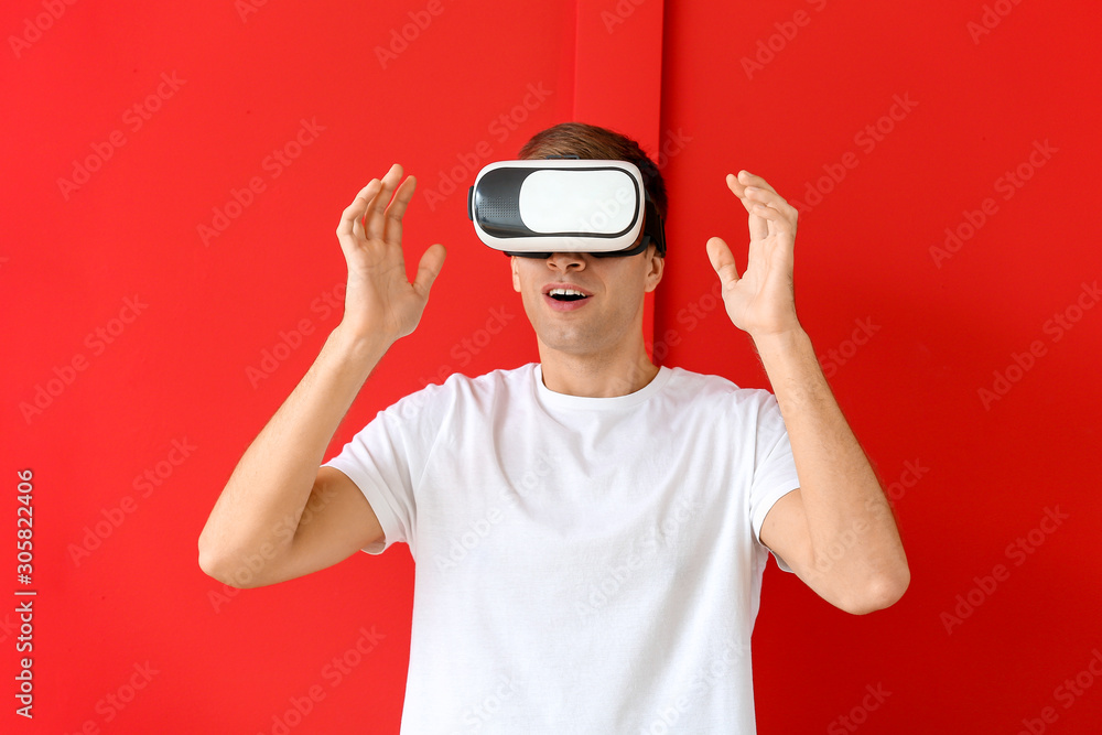 Young man with virtual reality glasses on color background Young man with virtual reality glasses on color background