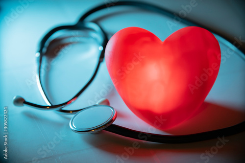 Εκτύπωση καμβά Red heart with stethoscope on blue background. Copy space