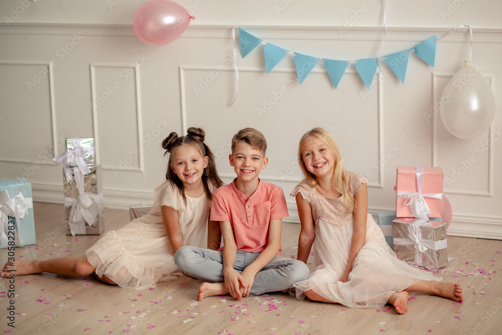 Happy birthday Happy cute children in festive decor and beautiful dresses play with confetti. Happy birthday Happy cute children in festive decor and beautiful dresses play with confetti.