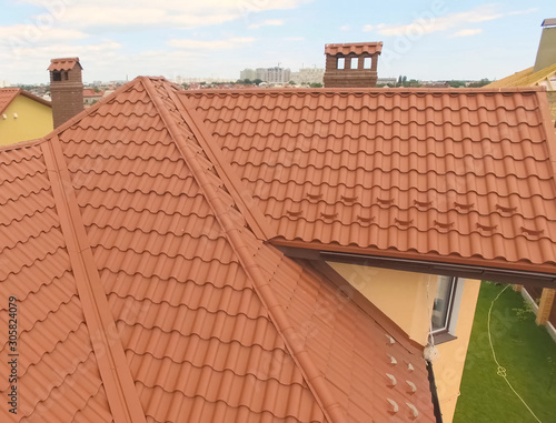 House with a new roof made of orange metal. View from above. Cor