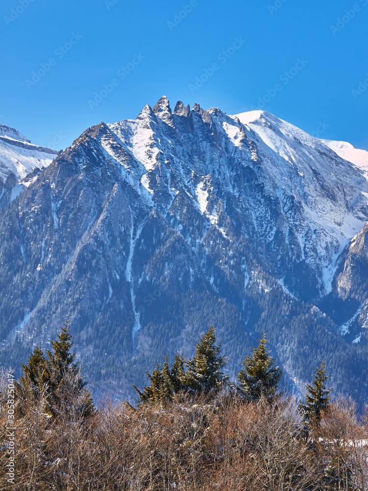 Epic view of pointy rock peaks called Acele Morarului in Bucegi mountains, Romania, in Winter.