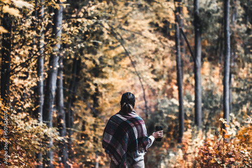 Wallpaper Mural Autumn girl standing backwards and watching nature. Autumn forest colors with girl back view. Torontodigital.ca