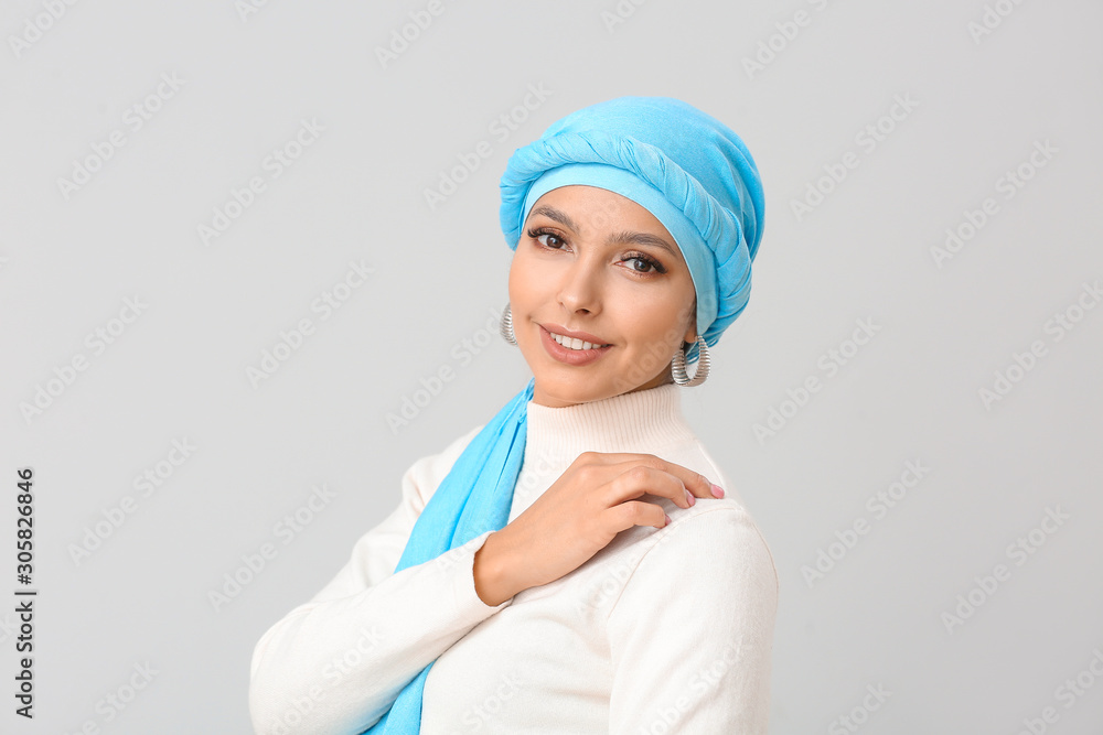 Portrait of beautiful Muslim woman on light background Portrait of beautiful Muslim woman on light background