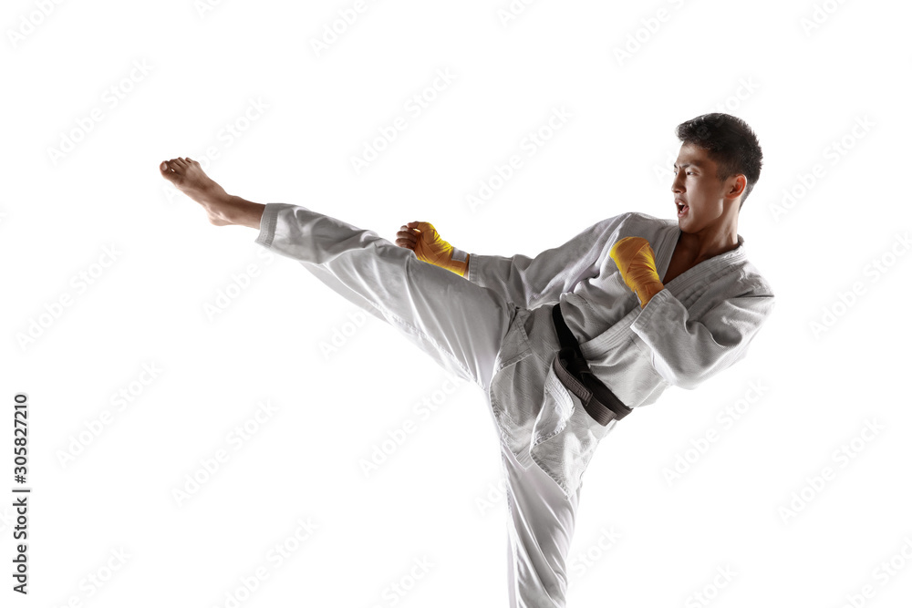 Confident korean man in kimono practicing hand-to-hand combat, martial arts. Young male fighter with black belt training isolated on white studio background. Concept of healthy lifestyle, sport. Confident korean man in kimono practicing hand-to-hand combat, martial arts. Young male fighter with black belt training isolated on white studio background. Concept of healthy lifestyle, sport.