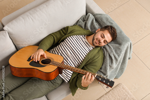 Handsome young man playing ...
