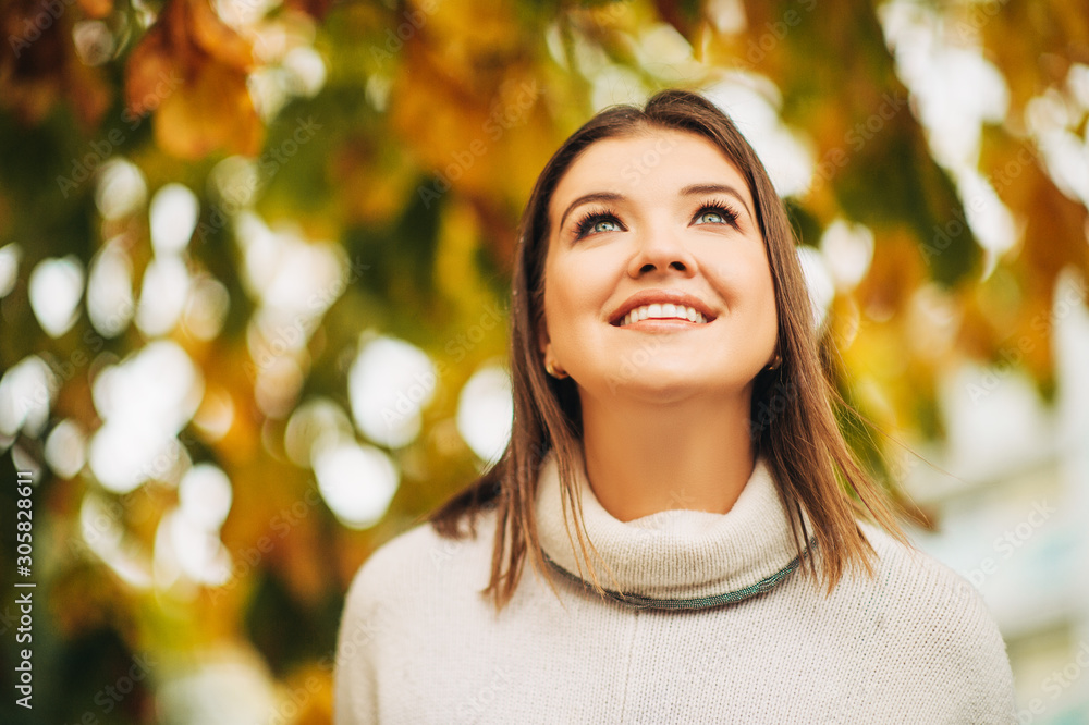 Autumn portrait of happy young woman in autumn garden, close up image Autumn portrait of happy young woman in autumn garden, close up image