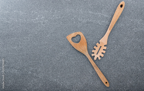 Pasta noodle spoon , Pasta scoop ladle and spatula on dark granite background with copy space..