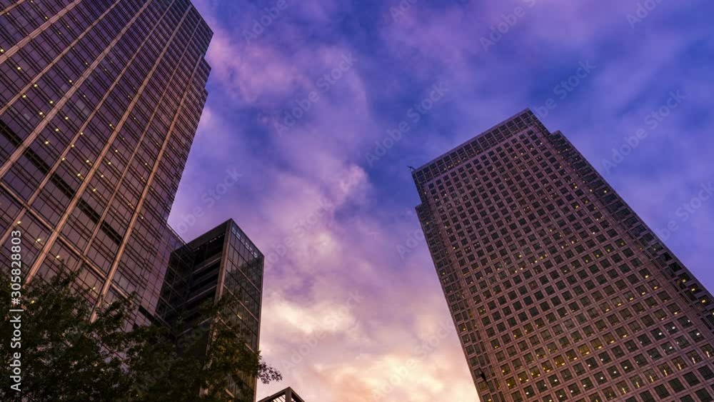 Day to night of a large office building with the lights coming on time lapse Day to night of a large office building with the lights coming on time lapse