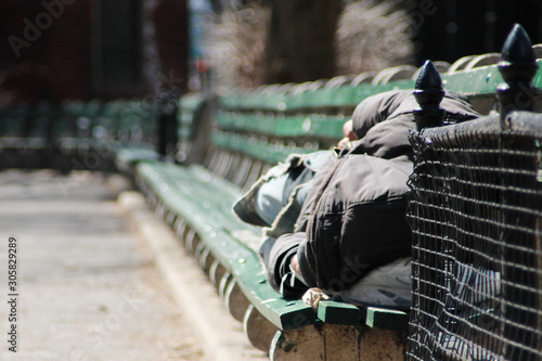A man sleeping on a bench in New York City © Athos