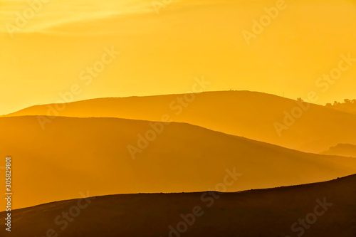 Layers of Mountains at Yellow Sunrise 