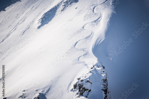 Freeride skier chilling on the cliff of slope