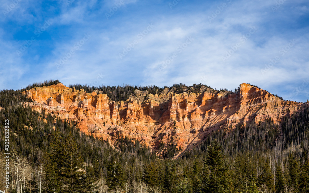 Red rock towers of Cedar Breaks Bryce Canyon, Southern Utah standing above the high elevation forest in early winter.