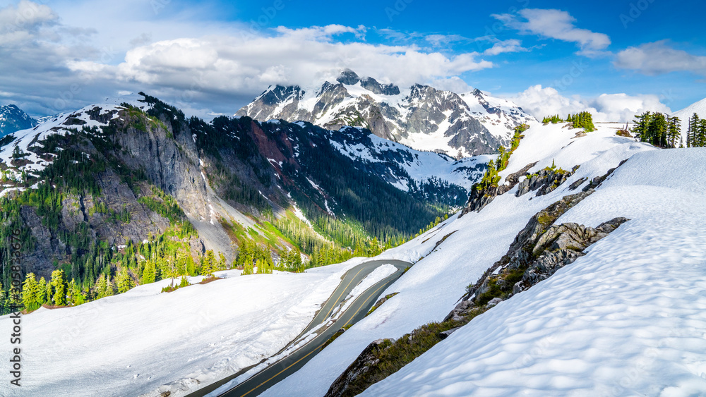 Mount Baker, Washington. USA. Winding mountain road trough snow with Mount Shuksan in the background.