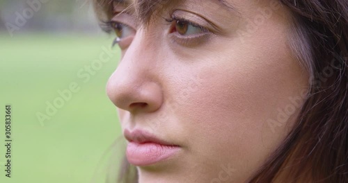 Extreme Close Up - A young woman looks off to the distance confidently - shot on RED photo