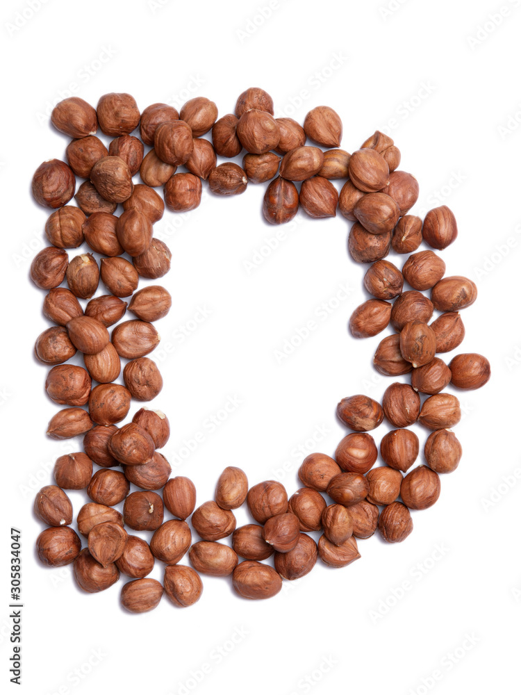Letter D of the English alphabet from from hazelnut on a white isolated background. Food pattern made from nuts. Bright alphabet for shops. Letter D of the English alphabet from from hazelnut on a white isolated background. Food pattern made from nuts. Bright alphabet for shops.