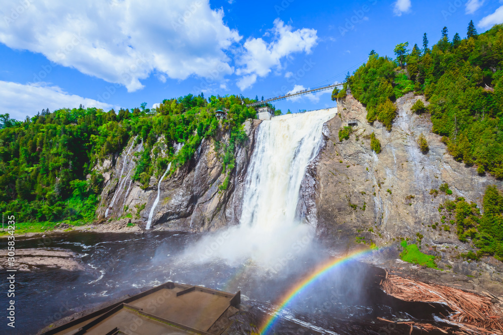 Naklejka premium Landscape View of Montmorency Falls and Magnificent Rainbow in Montmorency Falls Park, Quebec, Canada