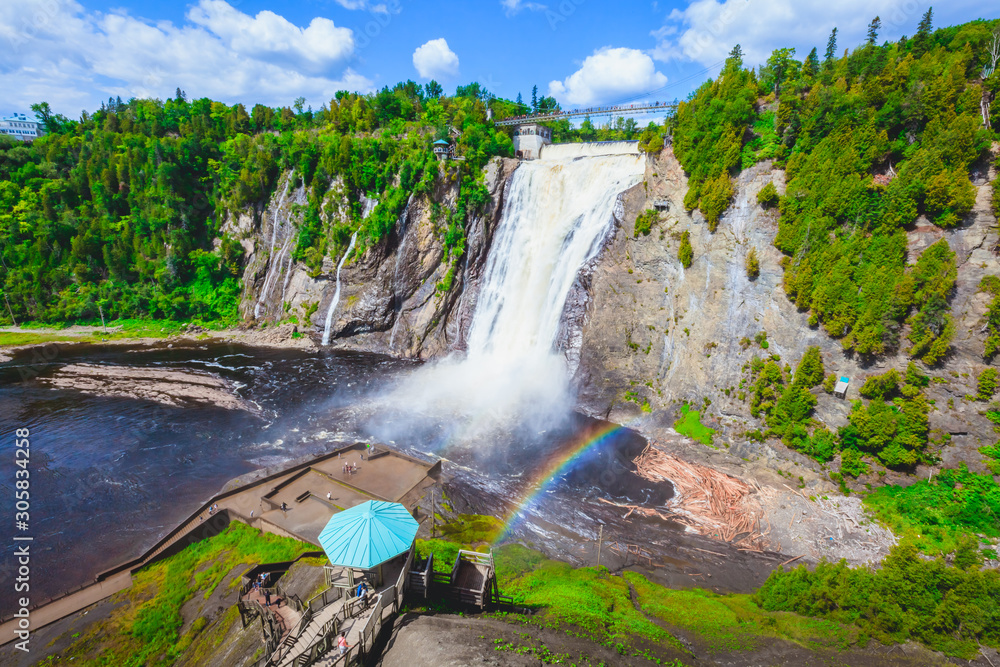 Naklejka premium Landscape View of Montmorency Falls and Magnificent Rainbow in Montmorency Falls Park, Quebec, Canada