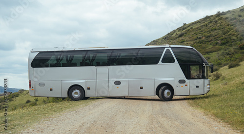 White BUS on the road in Geogrian Mountains