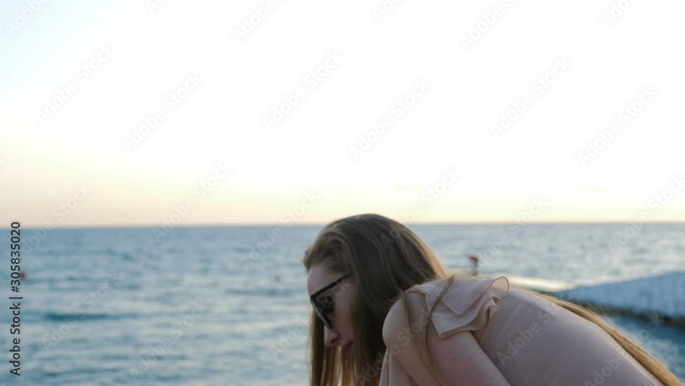 Portrait of young beautiful girl eating corn. Snacking on the sea Portrait of young beautiful girl eating corn. Snacking on the sea