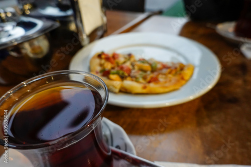 Istanbul, Turkey A cup of tea and a small Turkish pizza at an outdoor cafe in the Balat neighborhood.