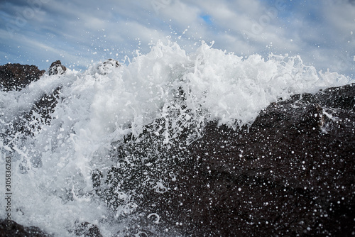 Waves crashing over rocks © ian