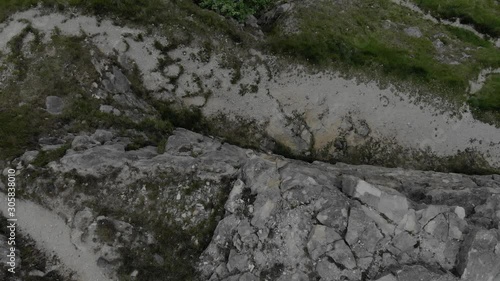 Wallpaper Mural Birds eye view of somebody hiking in The Cotswolds. Drone footage of somebody walking under a cliff edge. Torontodigital.ca