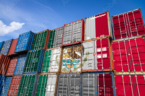The national flag of Mexico on a large number of metal containers for storing goods 