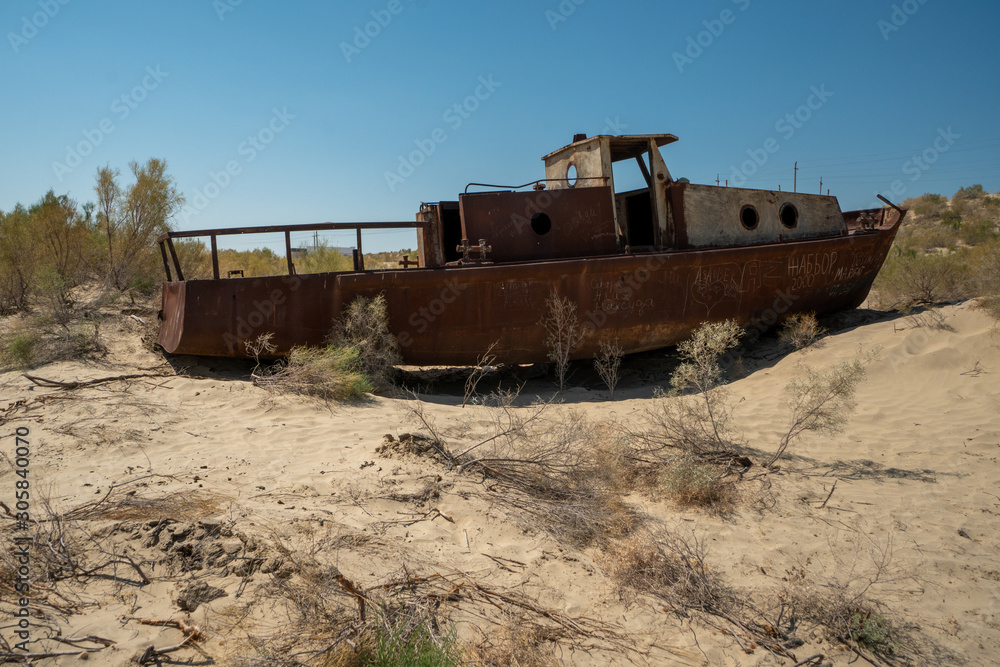 Rusty ship wreck in the deserted Aral Sea near Muynak en Uzbekistan Rusty ship wreck in the deserted Aral Sea near Muynak en Uzbekistan